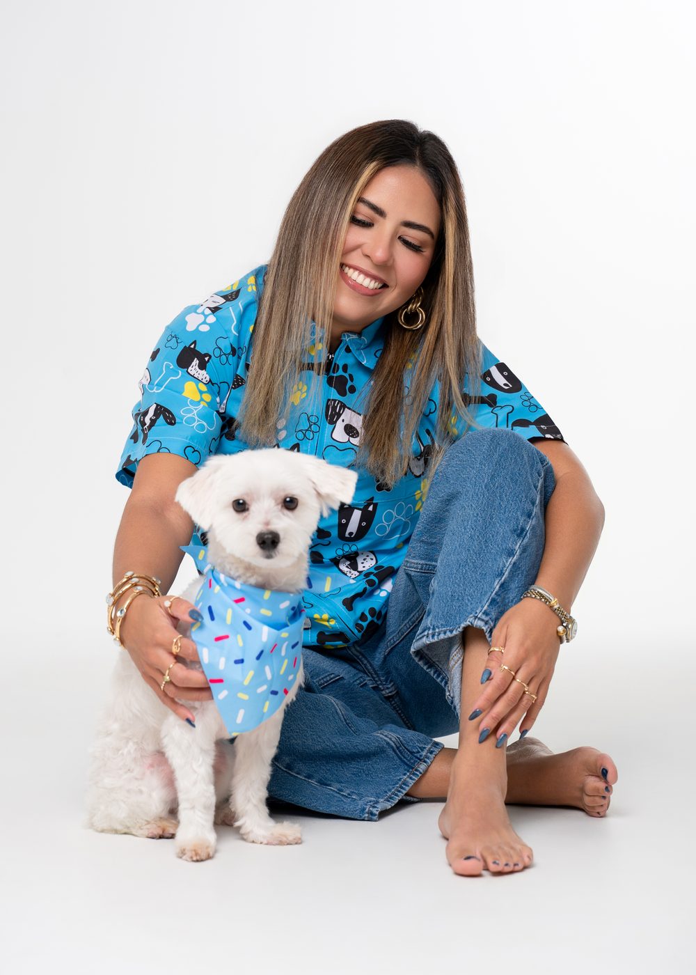 Vanessa sitting on the studio floor with Bubbles after a groom