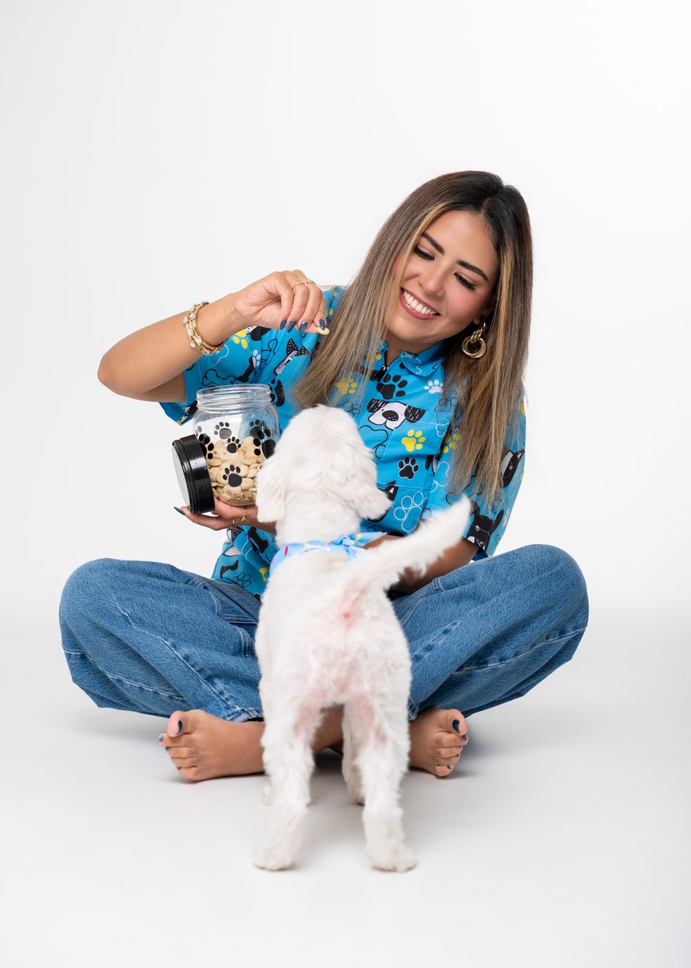 Vanessa offering a treat to Bubbles sitting with her